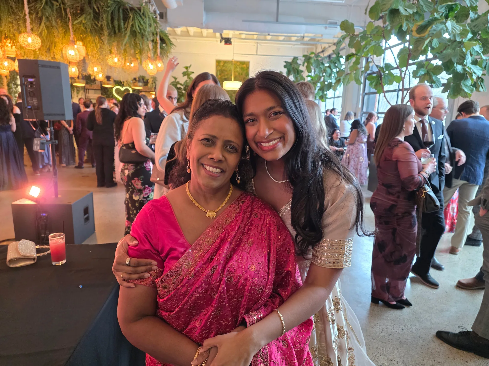 A mother and daughter smiling together at a celebration